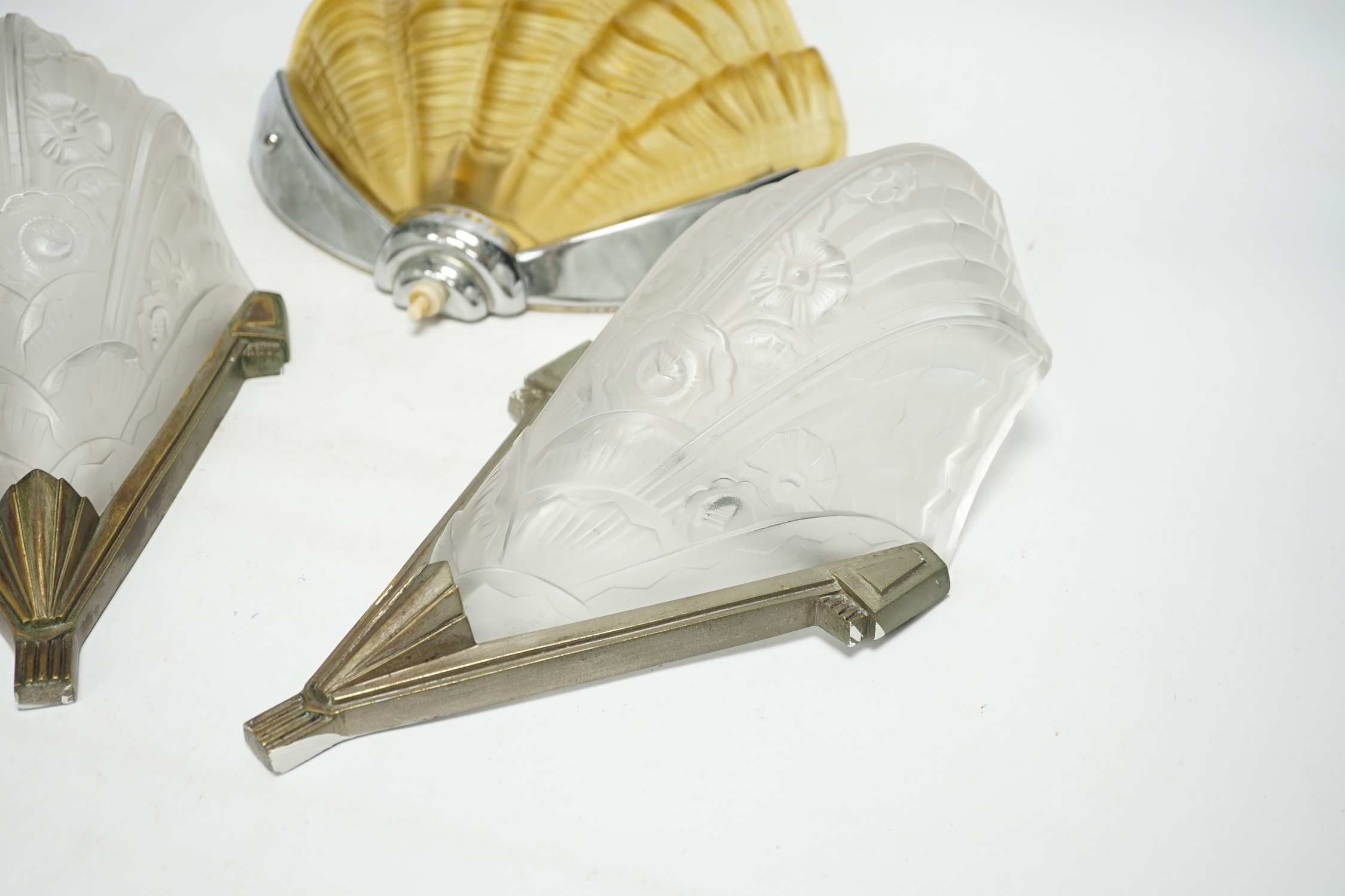 An Art Deco clam shell wall light and a pair of Art Deco wall lights, 30cm high (3). Condition - fair